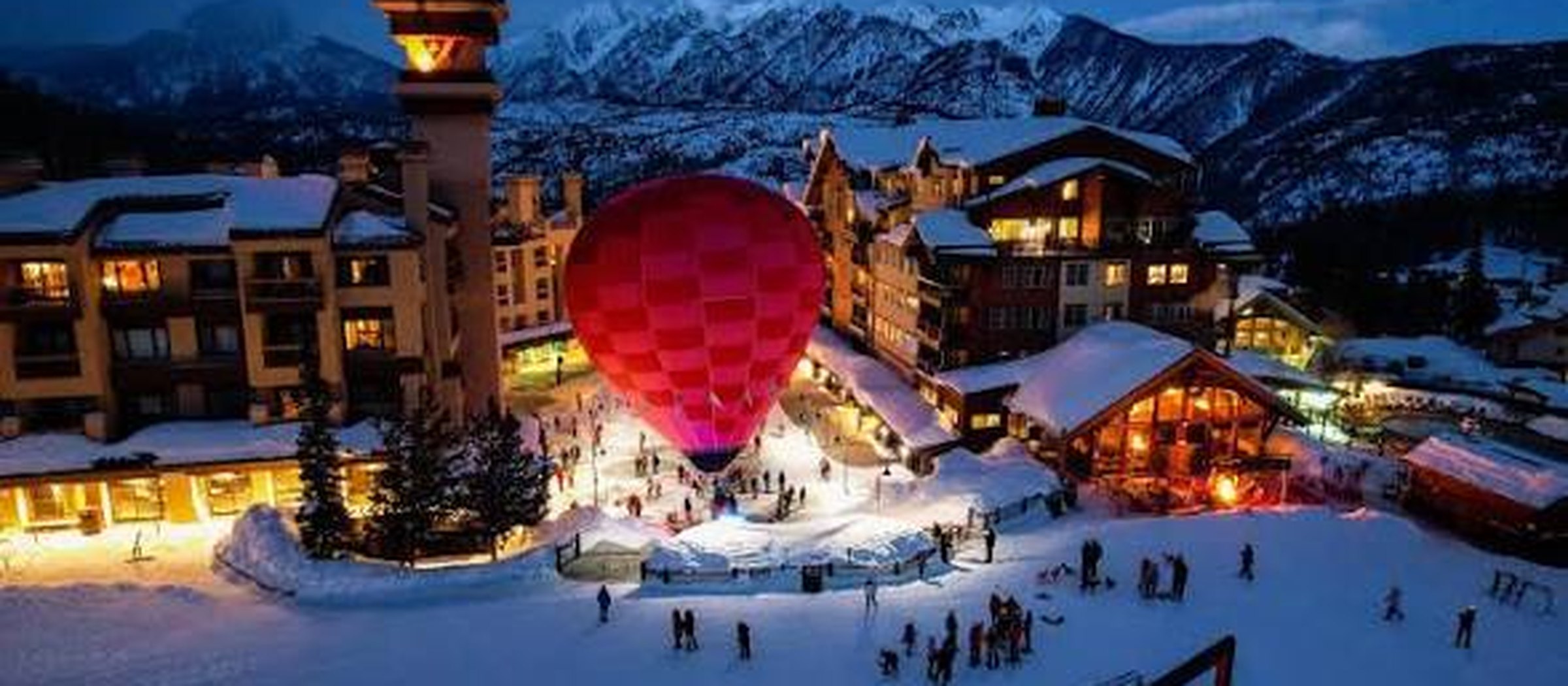 Purgatory village at night beneath snow-covered peaks
