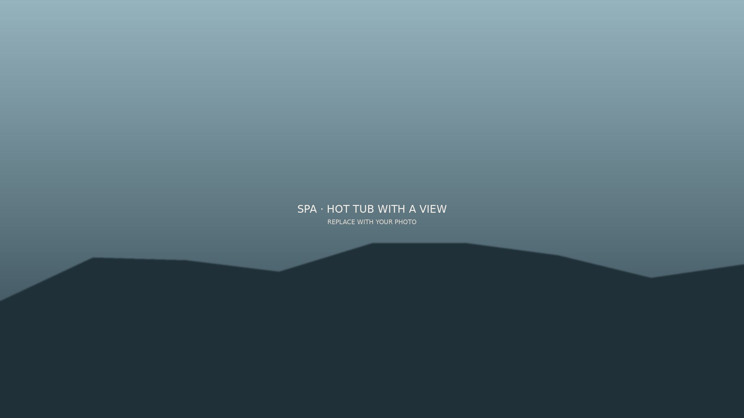 Steaming hot tub on a deck facing the mountains